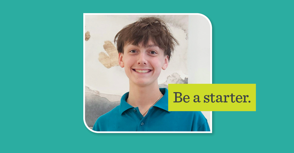 young man in blue collar shirt smiling