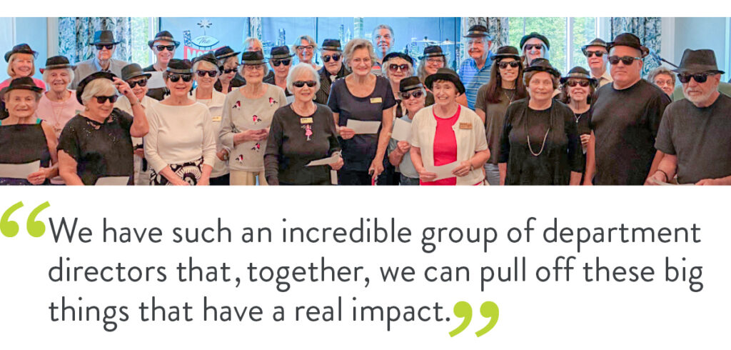 A group of older people and staff members of a senior living community. Underneath them is a quote that reads